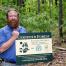 Quinte Conservation's Tim Trustham holds a new certification sign Thursday at Vanderwater Conservation Area near Tweed, ON